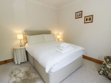 A bedroom with a bed and bedside lamps at Kala in Spittal near Haverfordwest