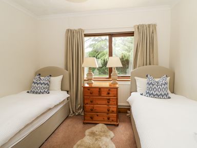 A bedroom with two single beds and a wooden dresser at Kala in Spittal near Haverfordwest
