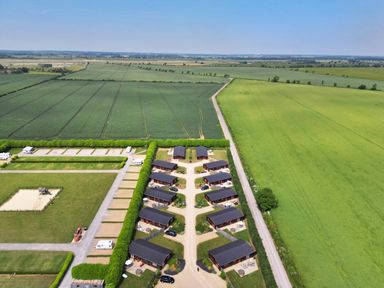 Aerial view of a property with multiple lodges arranged along pathways surrounded by fields at Oak Lodge in Greetham Rutland