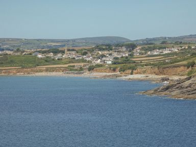 A coastal village with houses near a beach and fields in the background at Roncon's Villa in Goldsithney