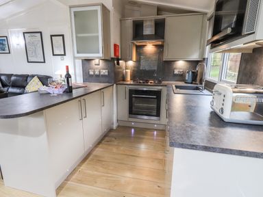 A kitchen with countertops oven stove toaster and kettle at Lavender Lodge in Applethwaite 4 Limefitt Park near Windermere