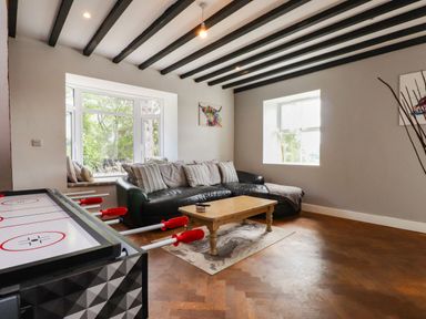 A living room with a sofa and coffee table at Tyddyn Elidir near Old Colwyn