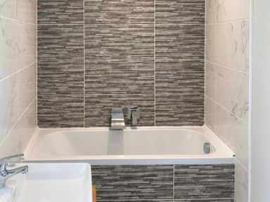 A bathroom with a bathtub and sink at Tyddyn Elidir near Old Colwyn