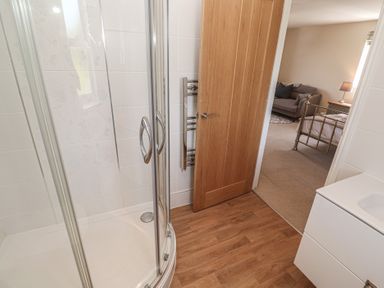 A bathroom with a shower and sink at Ilgram St Newlyn East