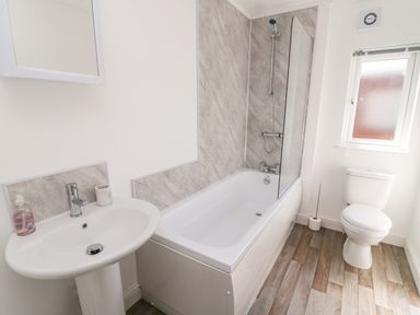 A bathroom with a sink a bathtub with shower a toilet and a window at Eden Lodge - Sherwood 21 South Lakeland Leisure Village