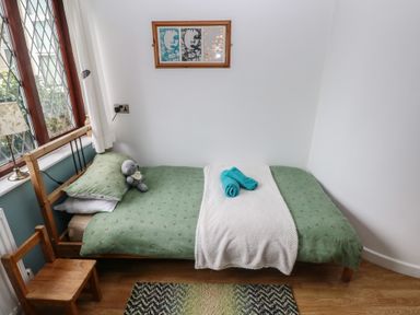 A bedroom with a bed and a toy at Llys-Yr-Onnen in Carmarthen