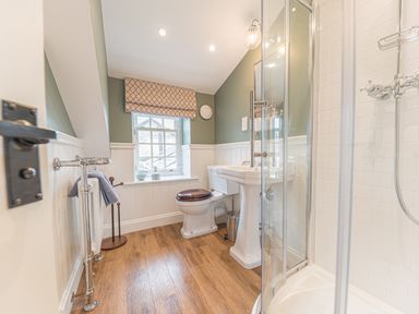 A bathroom with a toilet sink shower and window at Old Toffee Shop in Ambleside