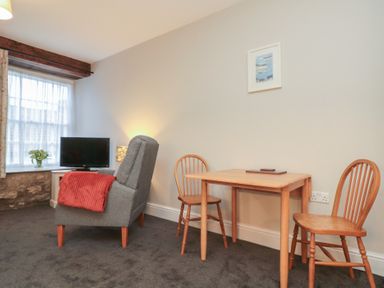 A living room with a sofa and table at Beck View