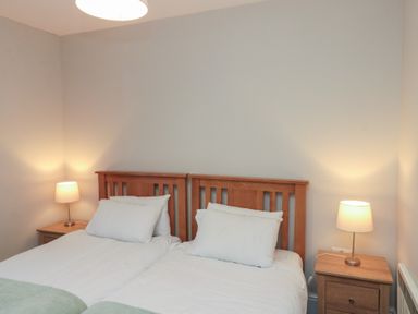 A bedroom with two beds and bedside lamps at Beck View