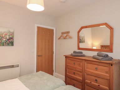A bedroom with a dresser and mirror at Beck View