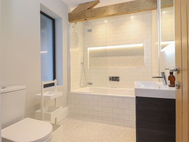 A bathroom with a toilet sink bathtub and shower at Hares Breath in Bowness On Windermere