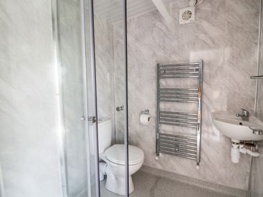 A bathroom with a toilet sink shower and heated towel rail at Caban Glas Llanafan near Pontrhydfendigaid