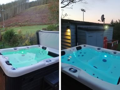 An outdoor hot tub with water illuminated by lights surrounded by grassy area and trees at Caban Glas in Llanafan near Pontrhydfendigaid