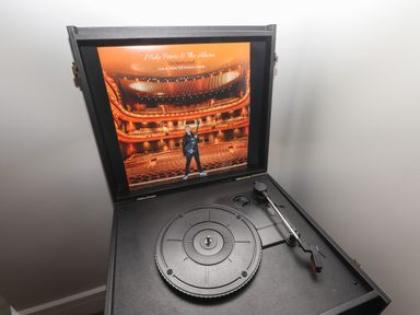 A record player with a vinyl album cover displayed at The Poppy Fields Abode in Dyserth
