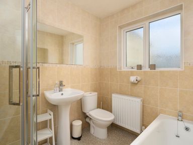 A bathroom with a pedestal sink toilet a shower enclosure and a bathtub at Saltwater Cottage in Babbacombe