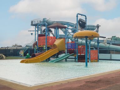A water play area with slides and water features in a shallow pool at 14 Fairways in Burnham-On-Sea