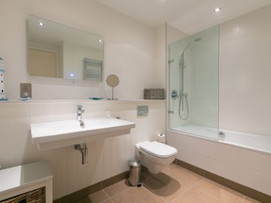 A bathroom with a sink toilet and bathtub with shower at Crystal Bay in St Ives