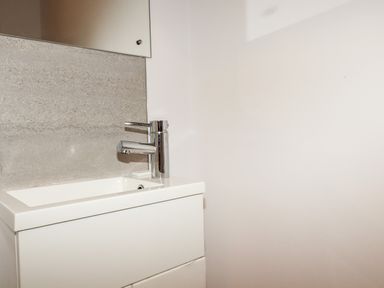 A bathroom sink with a chrome faucet and a soap bar on a gray countertop at 16 Ocean Heights in Newquay