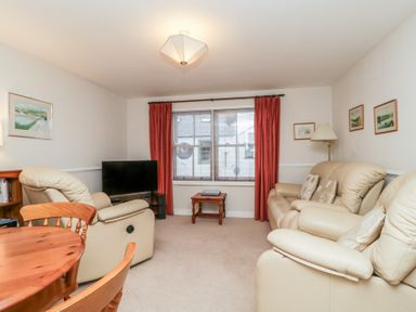 A living room with a sofa and television at Derwent Haven in Keswick