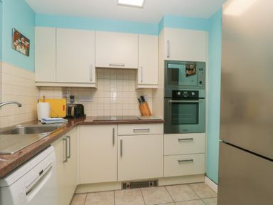 A kitchen with appliances and countertops at Derwent Haven in Keswick