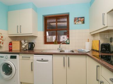 A kitchen with a sink and appliances at Derwent Haven Keswick