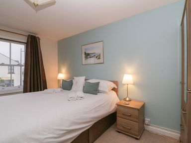 A bedroom with a bed and bedside table at Derwent Haven in Keswick
