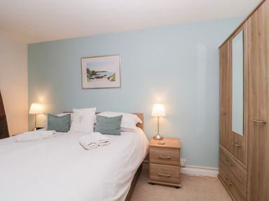 A bedroom with a bed and bedside tables at Derwent Haven in Keswick