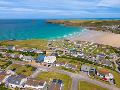 A coastal village with houses a caravan park and a beach by the sea at Zapadiah in Polzeath