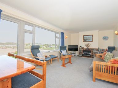A living room with furniture and ocean view at Zapadiah in Polzeath