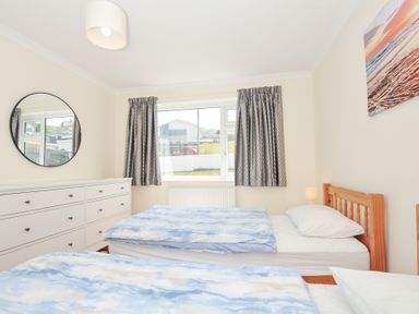 A bedroom with two beds and a mirror at Zapadiah in Polzeath