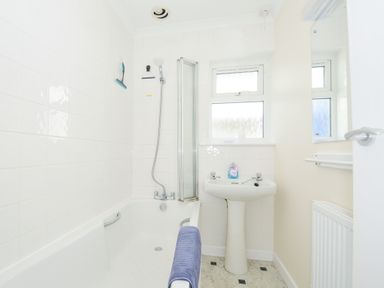 A bathroom with a bathtub sink and shower at Zapadiah in Polzeath