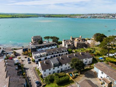 Aerial view of houses near a body of water with hills and a town in the background at Slipway 7 Rock