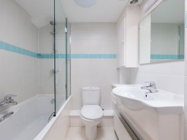 A bathroom with a bathtub shower combination toilet and sink at Slipway 7 in Rock