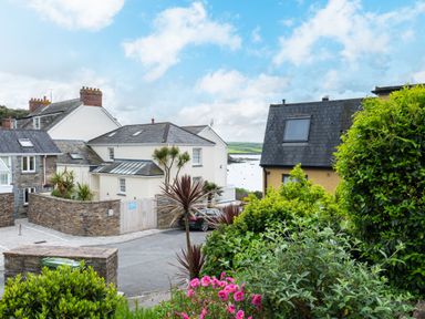 A street with houses trees and flowers near the coast at Slipway 7 in Rock