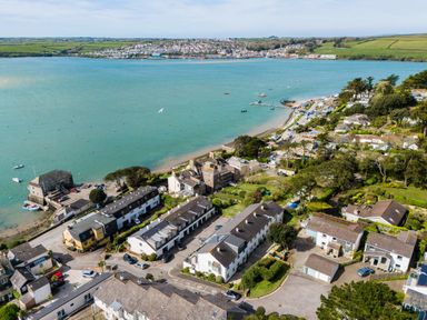 A coastal village with houses near the water and a bay with boats at Slipway 7 in Rock