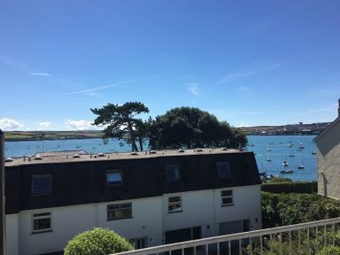 A view of boats on the water with houses and trees in the foreground at Slipway 10 in Rock