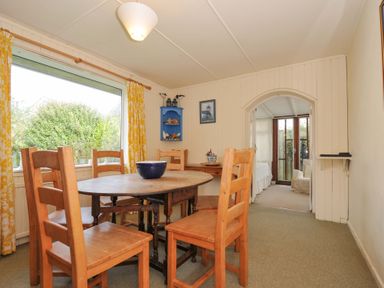 A dining room with a table and chairs at Avoca in Rock