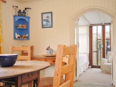 A dining room with a table and chairs at Avoca in Rock