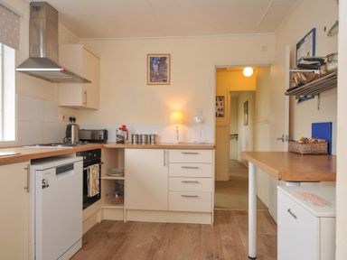 A kitchen with appliances and furniture at Avoca in Rock