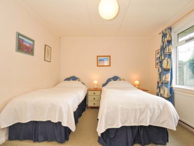 A bedroom with two beds and a window at Avoca in Rock
