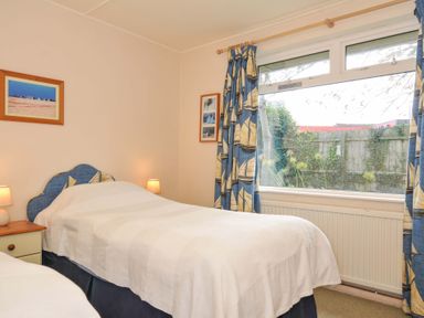 A bedroom with two single beds and a window at Avoca in Rock