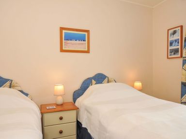 A bedroom with two beds and a bedside table at Avoca in Rock