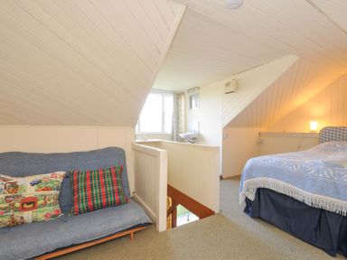 A bedroom with a sofa and a bed at Avoca in Rock