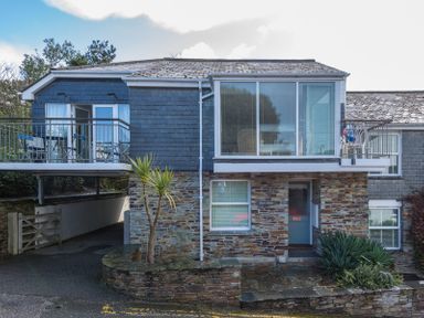 The exterior of a two-story house with balconies and stone facade at Slipway 19 in Rock
