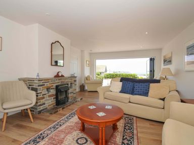 A living room with a sofa and coffee table at Sunset in Polzeath