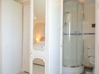 A bathroom with a shower and toilet at Sunset in Polzeath