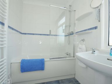 A bathroom with a bathtub and sink at Sunset in Polzeath