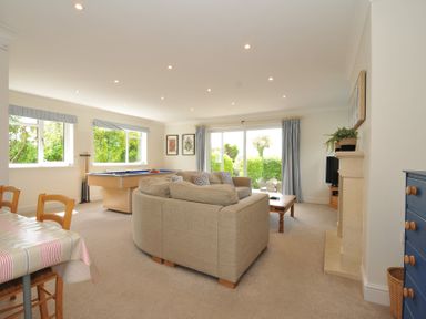 A living room with a sofa and pool table at Farlands in Daymer Bay