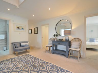 A hallway with a sofa and table at Farlands in Daymer Bay