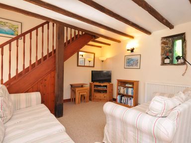 A living room with a staircase and furniture at The Granary in Rock
